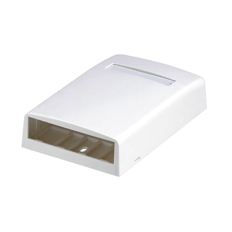The Mini-Com Surface Mount Box accepts four Mini-Com Modules. The box offers a variety of mounting options using adhesive tape, screws, or optional magnet. The box includes label pocket for easy identification and is arctic white.