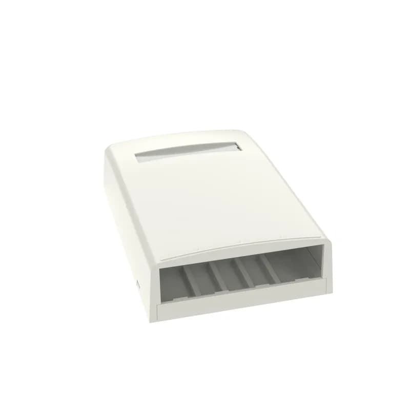 The Mini-Com Surface Mount Box accepts four Mini-Com Modules. The box offers a variety of mounting options using adhesive tape, screws, or optional magnet. The box includes label pocket for easy identification and is off white.