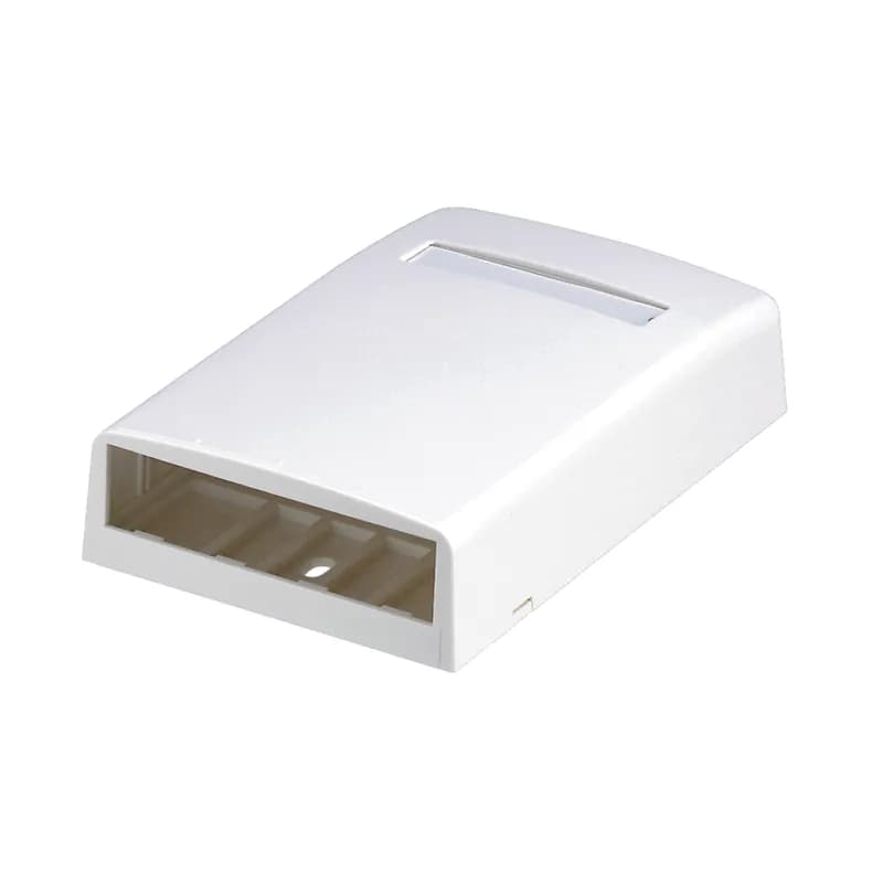 The Mini-Com Surface Mount Box accepts four Mini-Com Modules. The box offers a variety of mounting options using adhesive tape, screws, or optional magnet. The box includes label pocket for easy identification and is white.