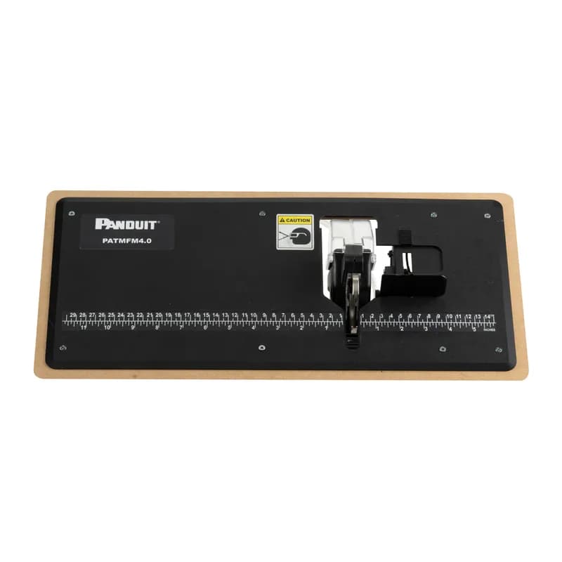 Panduit PATMFM4.0 flushmount fixture accessory for PAT4.0 eliminates the need to lift wire or cable bundle from work surface. It includes a hand actuated paddle that eliminates the traditional foot pedal common to bench mounts. It also includes an integral measuring device useful for applying cable ties for desired interval spacing.